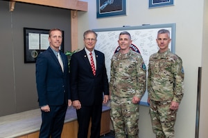 four men pose for group photo