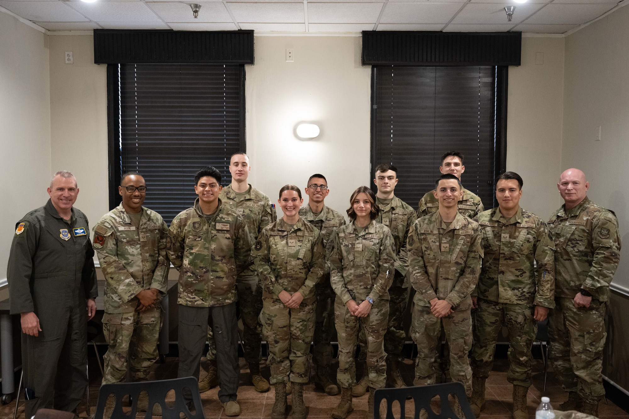 U.S. Air Force Maj. Gen. Charles Bolton, 18th Air Force commander, and Chief Master Sgt. Thomas Blount, 18th AF command chief, pose for a photo with Airmen assigned to the 317th Airlift Wing after an immersion visit breakfast at Dyess Air Force Base, Texas, April 2, 2025. The 18th AF command team spent the day meeting Airmen and touring various facilities to get a firsthand look at how the 317th AW is at the leading edge of tactical airlift. (U.S. Air Force photo by Airman Caleb Schellenberg)