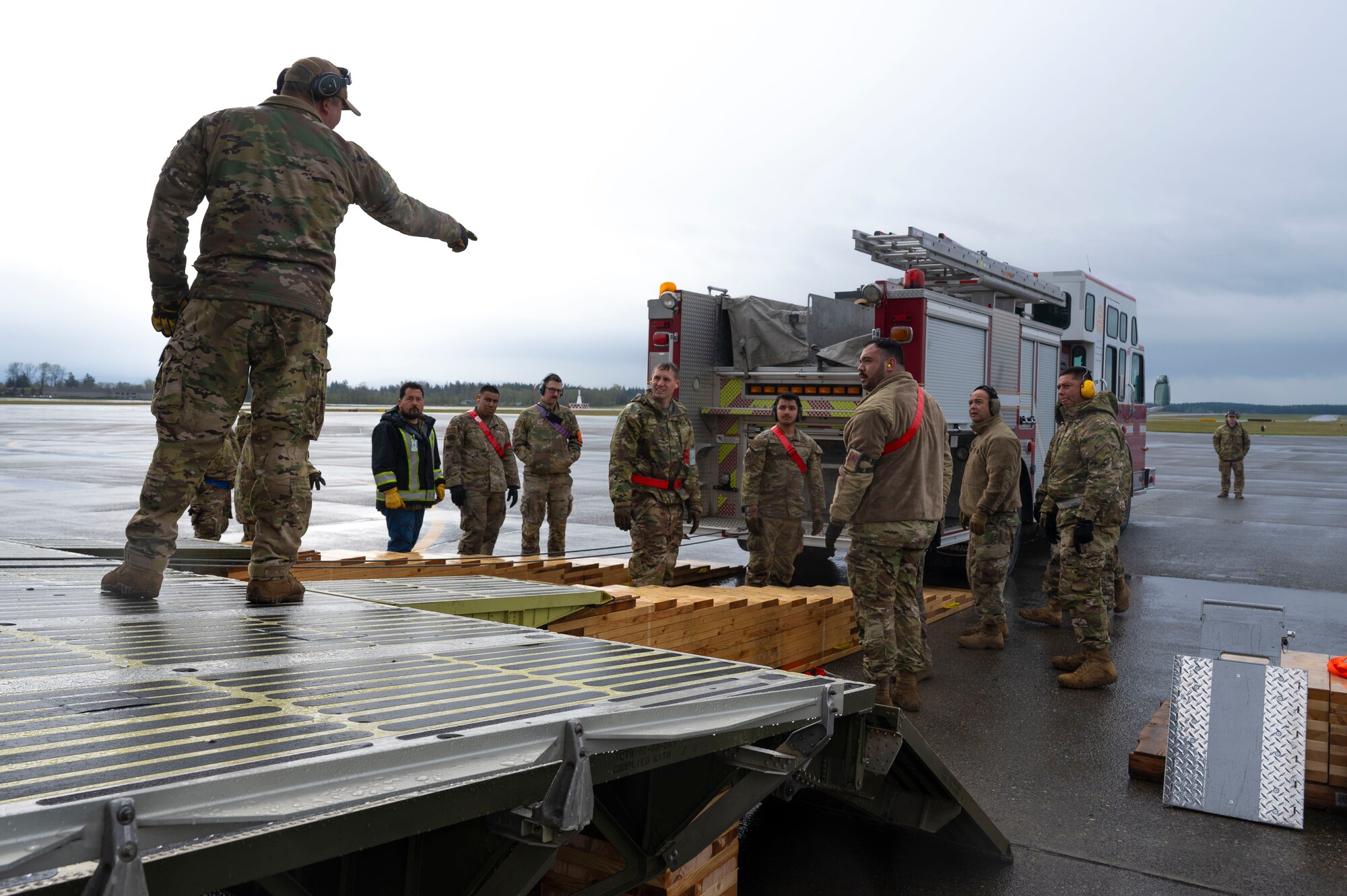 U.S. Air Force Airmen with the 62d Aerial Port Squadron, 446th APS and 709th Airlift Squadron from Dover Air Force Base, Delaware, load a fire truck onto a C-5M Super Galaxy at Joint Base Lewis-McChord, Washington, April 8, 2025. 
A donated fire truck arrived at JBLM via flatbed truck to be shipped to Guatemala in support of the Denton Humanitarian Assistance Program.