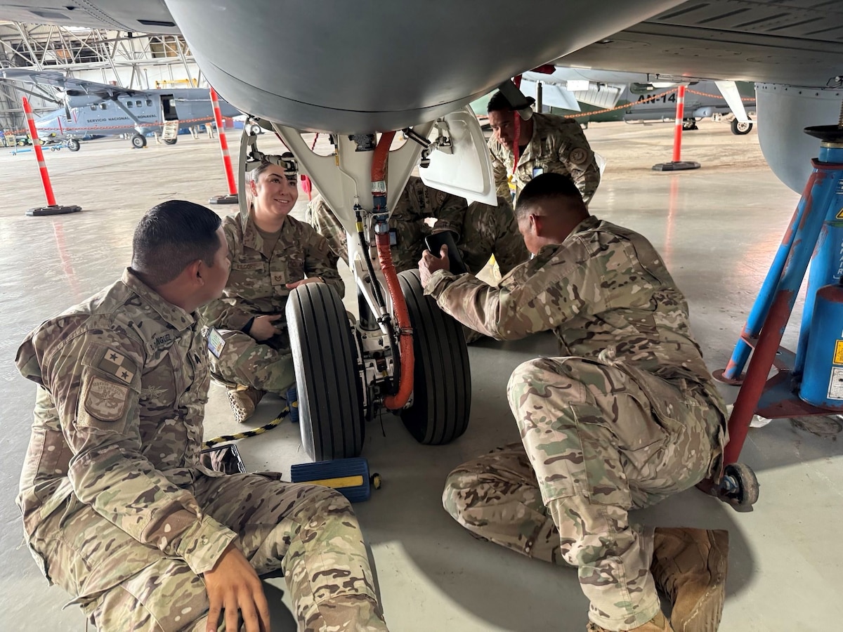 Airmen from the United States and Panama work on a jet.