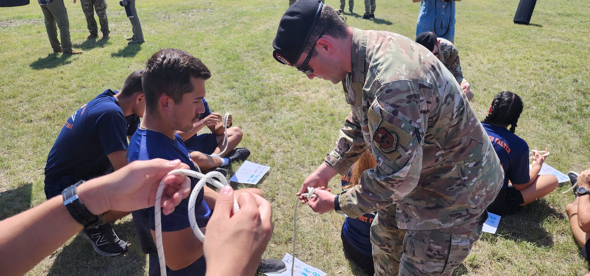 servicemember holding rope showing how to tie a knot
