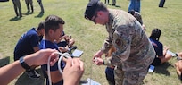 servicemember holding rope showing how to tie a knot