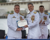 JOINT BASE PEARL HARBOR-HICKAM (April 11, 2025) – Rear Adm. Rick Seif, outgoing commander, Submarine Force, U.S. Pacific Fleet, left, receives his end-of-tour award from Adm. Steve Koehler, commander, U.S. Pacific Fleet, during the COMSUBPAC change of command ceremony aboard the Virginia-class fast-attack submarine USS Montana (SSN 794), April 11, 2025. The Pacific Submarine Force provides strategic deterrence; anti-submarine warfare; anti-surface warfare; precision land strike; intelligence, surveillance, reconnaissance, and early warning; and special warfare capabilities around the globe. (U.S. Navy photo by Mass Communication Specialist 1st Class Scott Barnes)