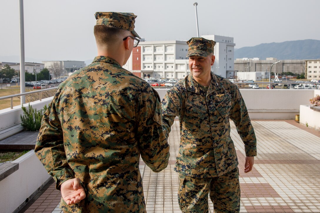 U.S. Marine Corps Col. Richard Rusnok Jr., right, the commanding officer of Marine Corps Air Station Iwakuni, and a Pennsylvania native, shakes hands with Sgt. Manuel A. Lopez Chavez, the meteorological & oceanographic platoon sergeant with Headquarters and Headquarters Squadron, Marine Corps Air Station Iwakuni, and a native of Florida, after receiving the 2024 METOC Marine of the Year Award at Marine Corps Air Station Iwakuni, Japan, March. 25, 2025. Enlisted METOC Marines who have excelled in their field are given the METOC Marine of the Year Award in recognition of their achievement and merit. (U.S. Marine Corps photo by Sgt. Randall Whiteman)