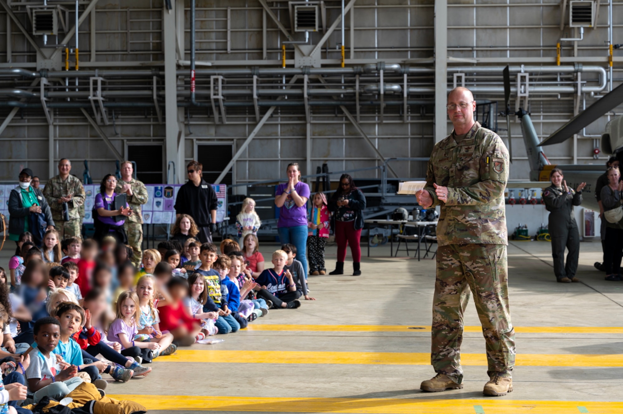 A military member speaks in front of a group of students.