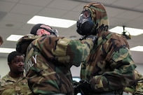 Airmen from the 166th Airlift Wing participate in a readiness exercise at Fort Indiantown Gap, Pennsylvania, on April 4, 2025. The Airmen demonstrated high standards of efficiency and readiness through various tasks, including field navigation tests, searching for unexploded ordnance, assembling and disassembling weapons, and donning Mission-Oriented Protective Posture gear. (U.S. Air National Guard photo by Airman Austin Stern)