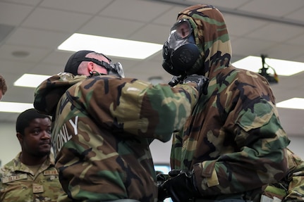 Airmen from the 166th Airlift Wing participate in a readiness exercise at Fort Indiantown Gap, Pennsylvania, on April 4, 2025. The Airmen demonstrated high standards of efficiency and readiness through various tasks, including field navigation tests, searching for unexploded ordnance, assembling and disassembling weapons, and donning Mission-Oriented Protective Posture gear. (U.S. Air National Guard photo by Airman Austin Stern)
