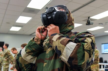 Airmen from the 166th Airlift Wing participate in a readiness exercise at Fort Indiantown Gap, Pennsylvania, on April 4, 2025. The Airmen demonstrated high standards of efficiency and readiness through various tasks, including field navigation tests, searching for unexploded ordnance, assembling and disassembling weapons, and donning Mission-Oriented Protective Posture gear. (U.S. Air National Guard photo by Airman Austin Stern)