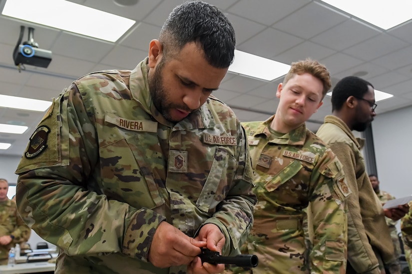 Airmen from the 166th Airlift Wing participate in a readiness exercise at Fort Indiantown Gap, Pennsylvania, on April 4, 2025. The Airmen demonstrated high standards of efficiency and readiness through various tasks, including field navigation tests, searching for unexploded ordnance, assembling and disassembling weapons, and donning Mission-Oriented Protective Posture gear. (U.S. Air National Guard photo by Airman Austin Stern)
