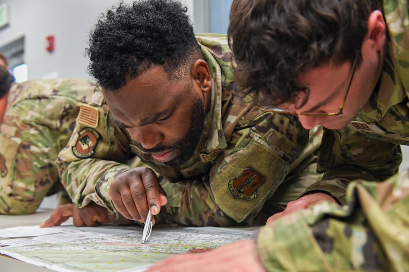 Airmen from the 166th Airlift Wing participate in a readiness exercise at Fort Indiantown Gap, Pennsylvania, on April 4, 2025. The Airmen demonstrated high standards of efficiency and readiness through various tasks, including field navigation tests, searching for unexploded ordnance, assembling and disassembling weapons, and donning Mission-Oriented Protective Posture gear. (U.S. Air National Guard photo by Airman Austin Stern)