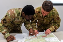 Airmen from the 166th Airlift Wing participate in a readiness exercise at Fort Indiantown Gap, Pennsylvania, on April 4, 2025. The Airmen demonstrated high standards of efficiency and readiness through various tasks, including field navigation tests, searching for unexploded ordnance, assembling and disassembling weapons, and donning Mission-Oriented Protective Posture gear. (U.S. Air National Guard photo by Airman Austin Stern)