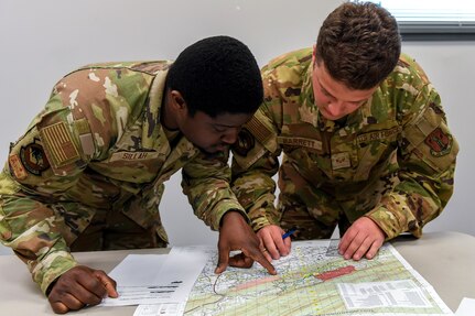 Airmen from the 166th Airlift Wing participate in a readiness exercise at Fort Indiantown Gap, Pennsylvania, on April 4, 2025. The Airmen demonstrated high standards of efficiency and readiness through various tasks, including field navigation tests, searching for unexploded ordnance, assembling and disassembling weapons, and donning Mission-Oriented Protective Posture gear. (U.S. Air National Guard photo by Airman Austin Stern)