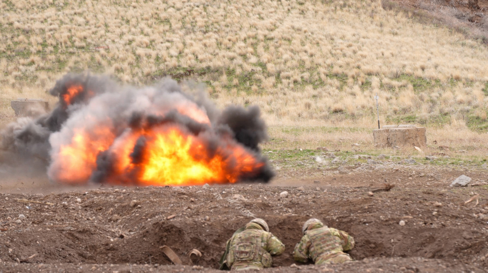 An infantryman and an engineer range safety detonate a claymore mine from a crater position during demolitions training at Yakima Training Center, Wash., March 31, 2025.