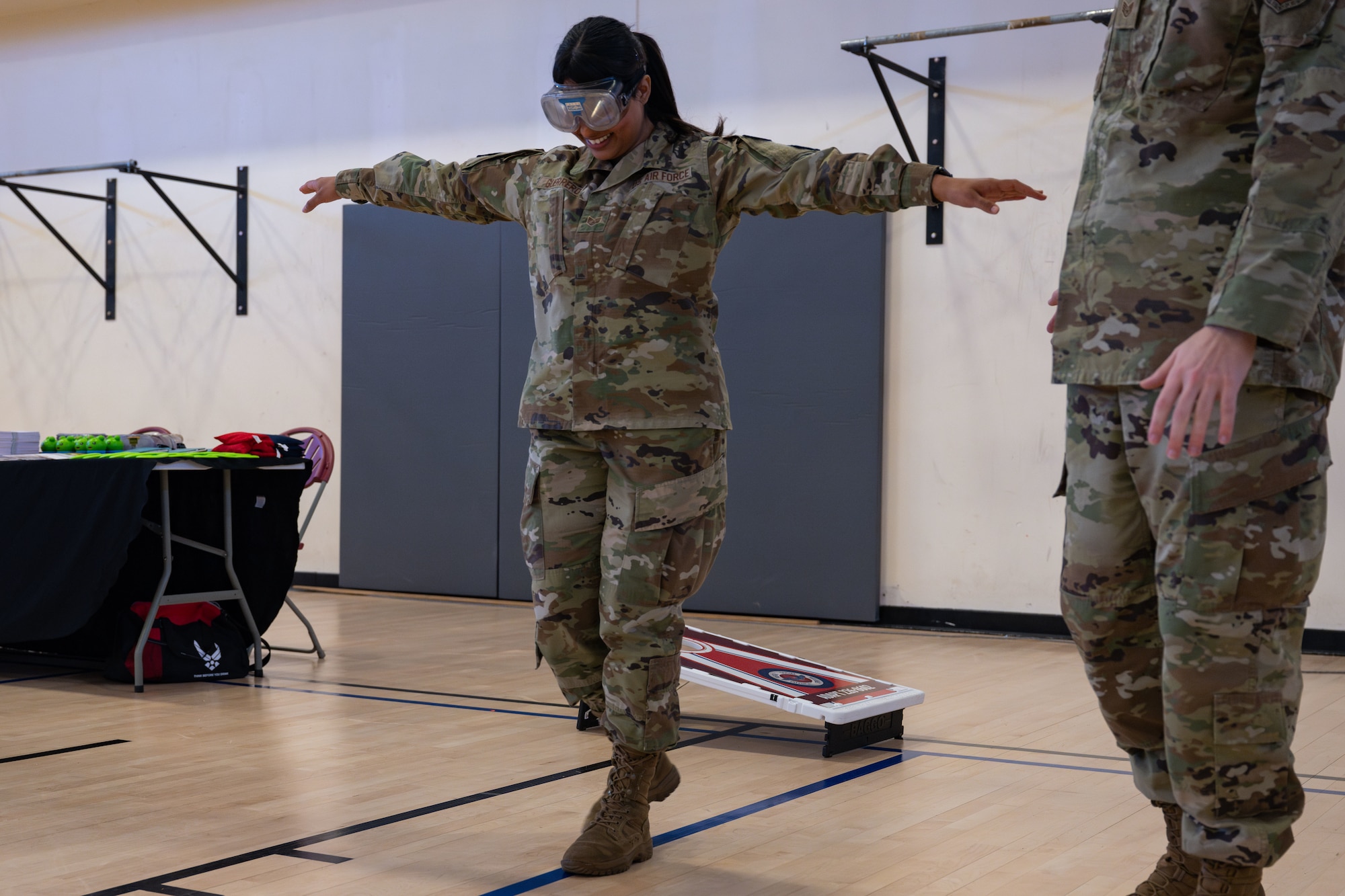 U.S. Air Force Staff Sgt. Virginia Guerrero, 48th Fighter Wing Judge Advocate victims paralegal, attempts to walk in a straight line while wearing vision impairment goggles during the SAFER Resilience Day event at RAF Mildenhall, England, April 11, 2025.