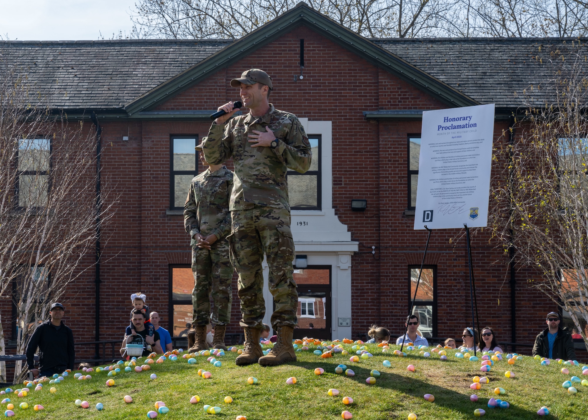 U.S. Air Force Col. Ryan Garlow, 100th Air Refueling Wing commander, speaks about the importance of the Month of the Military Child proclamation during the Eggstravaganza event at RAF Mildenhall, England, April 12, 2025.