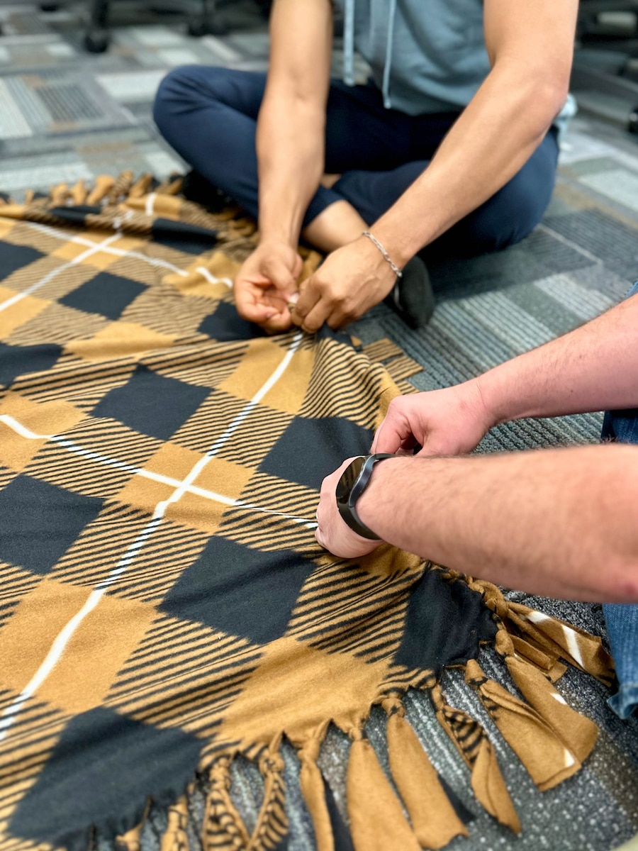 U.S. Air Force Airmen from class 25-3, Lankford Enlisted Professional Military Education, create a blanket for children in need across East Tennessee, McGhee Tyson Air National Guard Base, Tennessee, April 9, 2025.  Airman Leadership School and Non-Commissioned Officers Academy students serve the East Tennessee community by committing more than 150 hours of their off-duty time to making blankets.