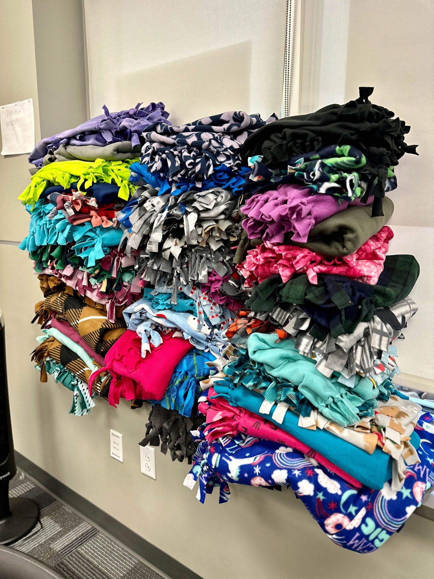 U.S. Air Force Airmen from class 25-3, Lankford Enlisted Professional Military Education, create 61 blankets for children in need across East Tennessee, McGhee Tyson Air National Guard Base, Tennessee, April 9, 2025.  Airman Leadership School and Non-Commissioned Officers Academy students serve the East Tennessee community by committing more than 150 hours of their off-duty time to making blankets.