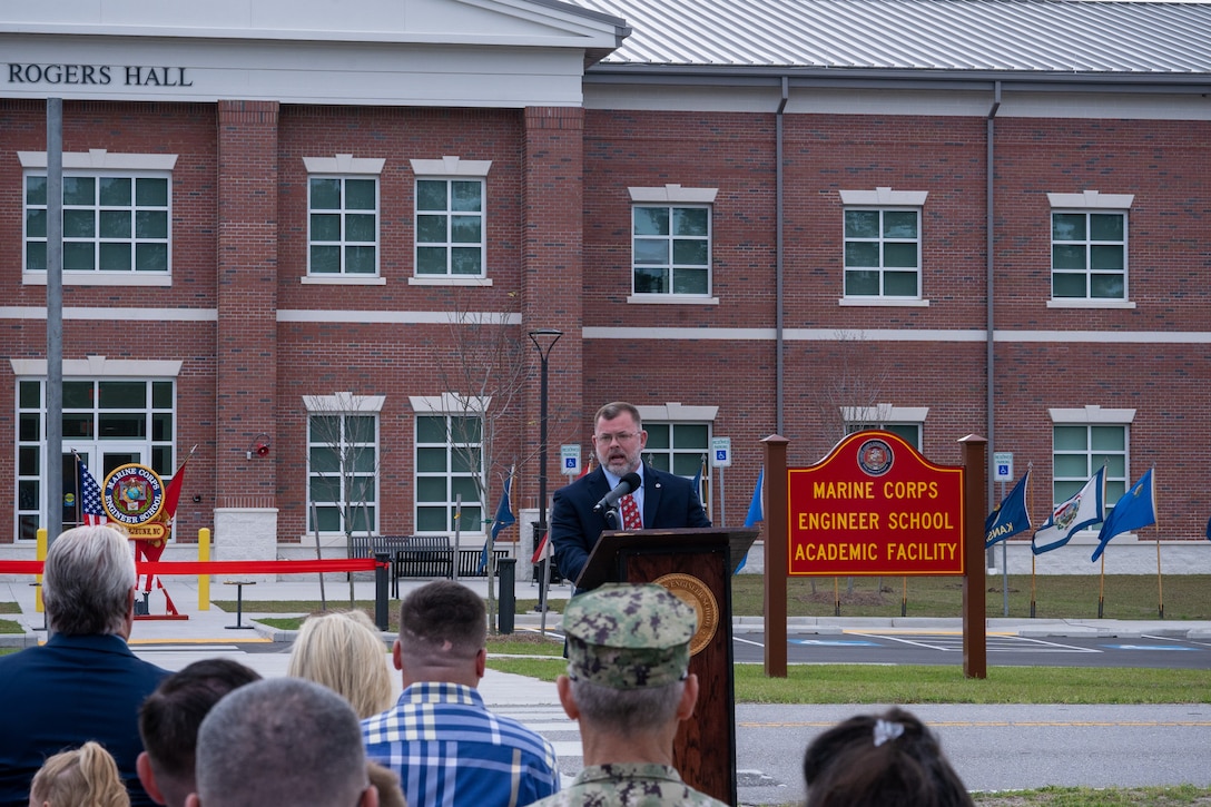 Retired U.S. Marine Corps Sgt. Maj. Bobby D. Frazier, gives remarks during a ribbon cutting and dedication ceremony at Marine Corps Engineer School on Marine Corps Base Camp Lejeune, North Carolina, April 4, 2025. The ceremony marked the opening of Rogers Hall, named in honor of U.S. Marine Corps Staff Sgt. Jason A. Rogers, who was killed in action during Operating Enduring Freedom. Rogers was recognized for his heroic sacrifice where he lost his life to an improvised explosive device while clearing a medical evacuation path for two of his Marines who were critically wounded. (U.S. Marine Corps photo by Cpl. Leo Amaro)