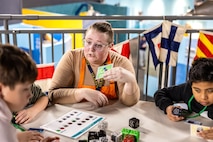Carolyn Lane, Puget Sound Navy Museum education specialist, discusses Cubeleto Robot Cubes, April 19, 2025, during 'Navy STEM Days' at the U.S. Naval Undersea Museum, in Keyport, Washington. (U.S. Navy photo by Jeb Fach)