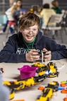 A student from Emerald Heights Elementary School operates an electric machine arm during April 19, 2025, during “Navy STEM Days” at the U.S. Naval Undersea Museum, in Keyport, Washington. (U.S. Navy photo by Jeb Fach)