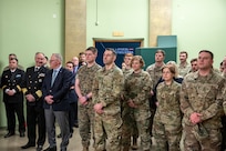 U.S. and Latvian service members listen as speakers address the audience during the opening of a new exhibit commemorating 32 years of U.S.-Latvian military partnership at the Latvian War Museum in Riga, Latvia, April 11, 2025.