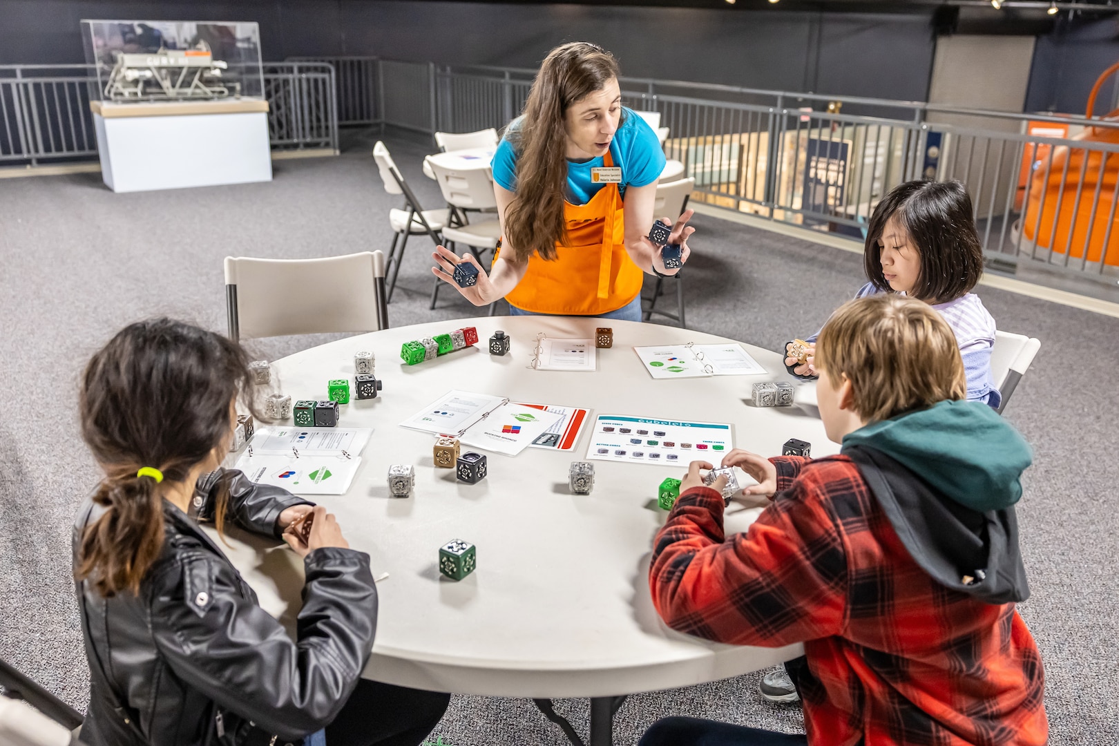Valerie Johnson, education specialist, U.S. Naval Undersea Museum works with a group students April 19, 2025, during “Navy STEM Days” at the U.S. Naval Undersea Museum, in Keyport, Washington. (U.S. Navy photo by Jeb Fach)