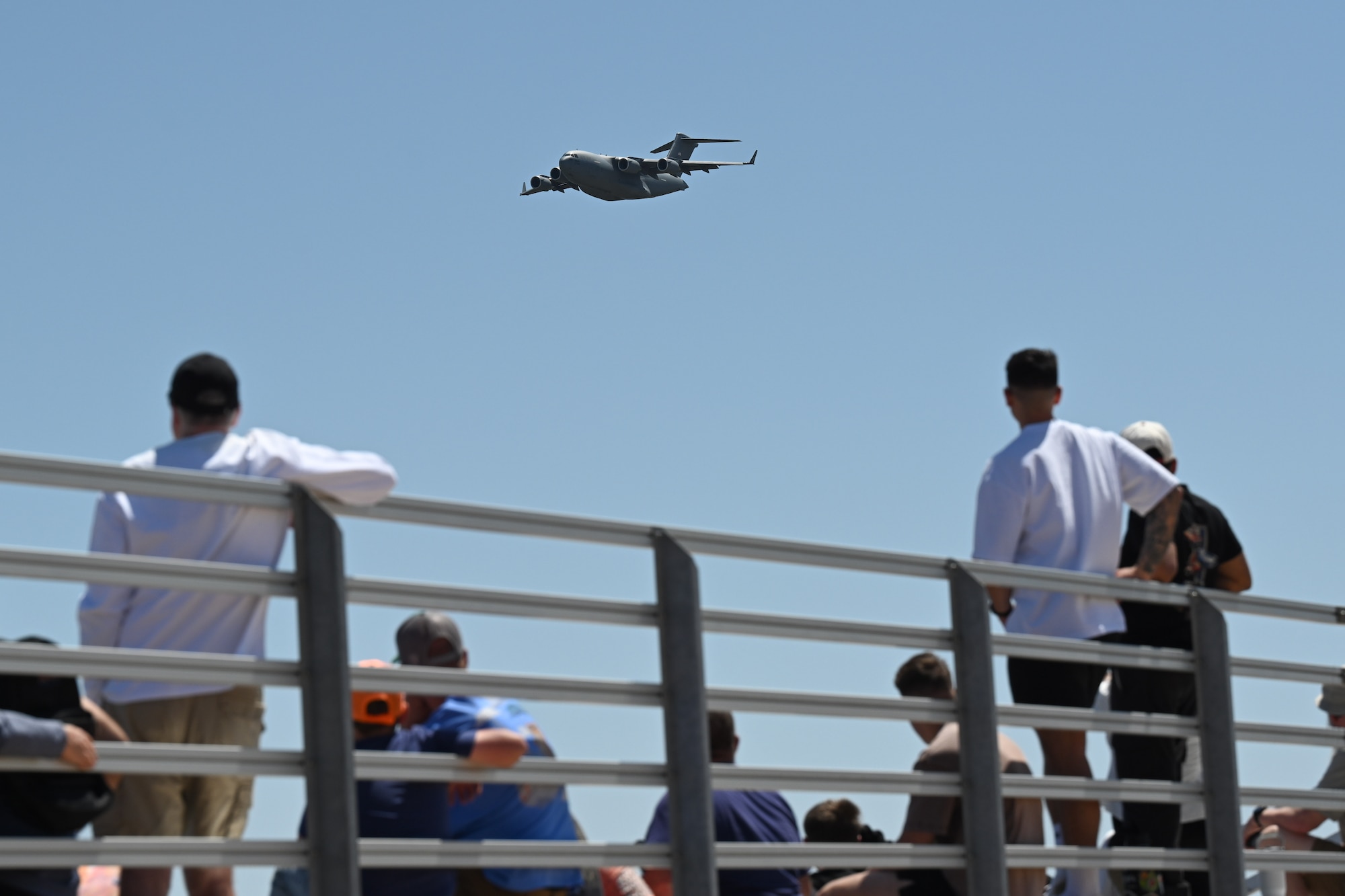 Attendees of the Altus Airpower Stampede Open House and Air Show view the 97th Air Mobility Wing’s C-17 Globemaster III Demonstration Team perform at Altus Air Force Base, Oklahoma, April 12, 2025. The Demonstration Team performed a high-speed pass, low-speed pass, and assault landing. (U.S. Air Force photo by Airman 1st Class Jonah Bliss)