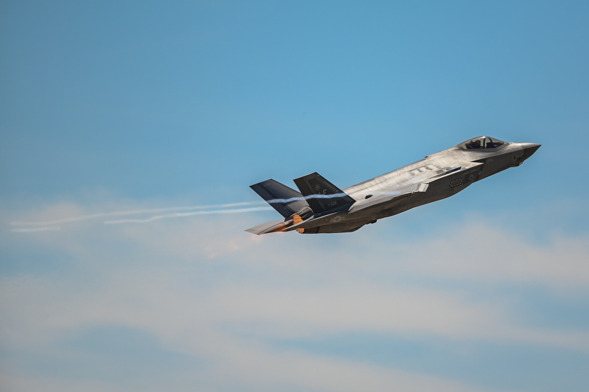 A U.S. Air Force F-35A Lightning II aircraft from Luke Air Force Base (AFB), Arizona, performs a flyover at the Altus Airpower Stampede Open House and Air Show at Altus AFB, Oklahoma, April 13, 2025. The F-35A can withstand up to 9Gs and delivers acceleration and agility, making it effective in both air-to-air and air-to-surface combat operations. (U.S. Air Force photo by Airman 1st Class Jonah Bliss)
