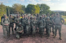 Senior noncommissioned officers dressed in OCP's posing for a photo, each member is of a different race.