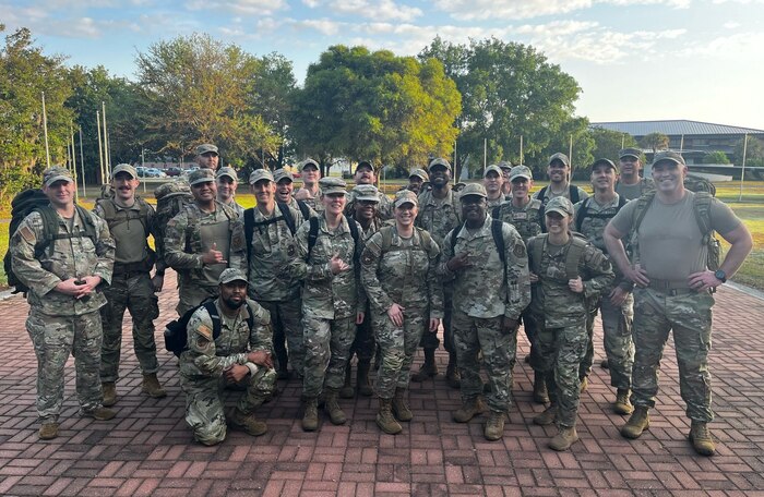 Senior noncommissioned officers dressed in OCP's posing for a photo, each member is of a different race.