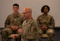Caucasian Chief Master Sgt. introducing an Airman's panel to the room of senior noncommissioned officers.