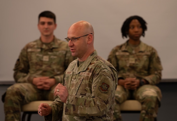 Caucasian Chief Master Sgt. introducing an Airman's panel to the room of senior noncommissioned officers.