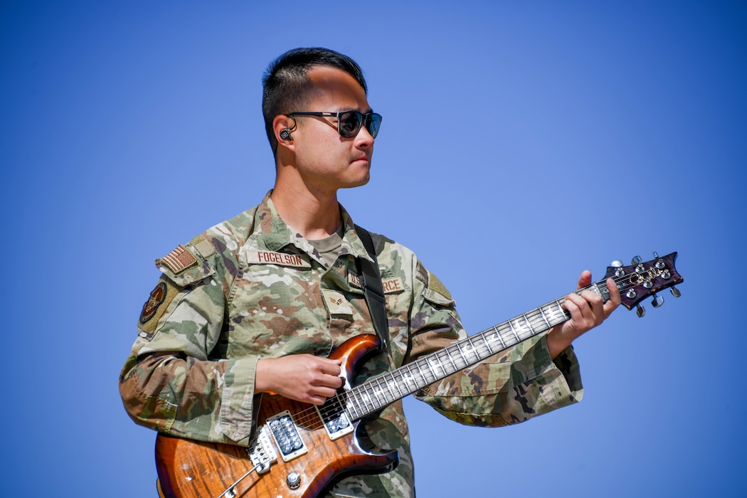 U.S. Air Force Senior Airman Allan Fogelson, Air Force Band of the West guitarist, plays a song during the Altus Airpower Stampede Open House and Airshow at Altus Air Force Base, Oklahoma, April 12, 2025. The Band of the West travels more than 125,000 miles annually and provides hundreds of performances to military and civilian audiences. (U.S. Air Force photo by Senior Airman Miyah Gray)
