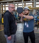 Jack Housley, project lead, Code 100TO.3, Innovation and Technology Integration, shows Harrison Belyea, plates bay manager, Shop 11, Shipfitters, how leak detectors work, April 3, 2025, at Puget Sound Naval Shipyard & Intermediate Maintenance Facility in Bremerton, Washington. (U.S. Navy photo by Wendy Hallmark)
