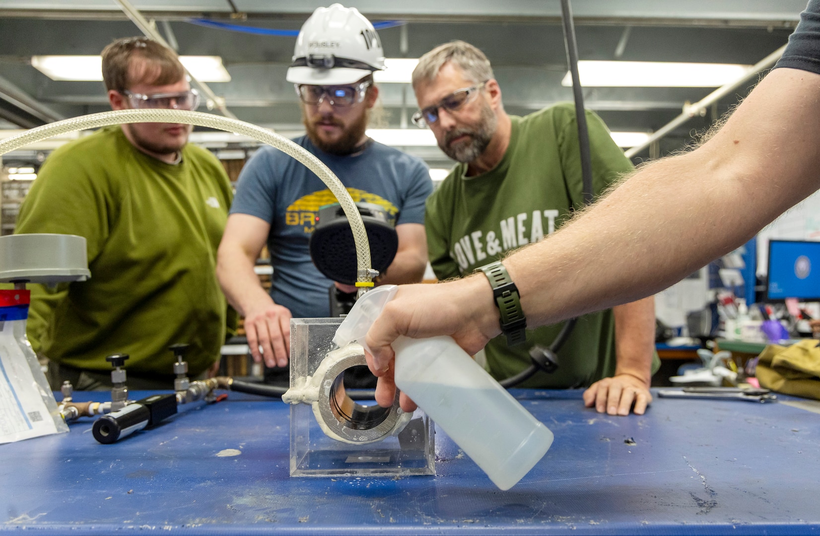 A spray bottle filled with soapy water is used to demonstrate the old-fashioned way of conducting leak-detection tests at Puget Sound Naval Shipyard & Intermediate Maintenance Facility in Bremerton, Washington. (U.S. Navy photo by Wendy Hallmark)