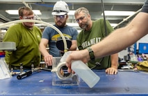 A spray bottle filled with soapy water is used to demonstrate the old-fashioned way of conducting leak-detection tests at Puget Sound Naval Shipyard & Intermediate Maintenance Facility in Bremerton, Washington. (U.S. Navy photo by Wendy Hallmark)