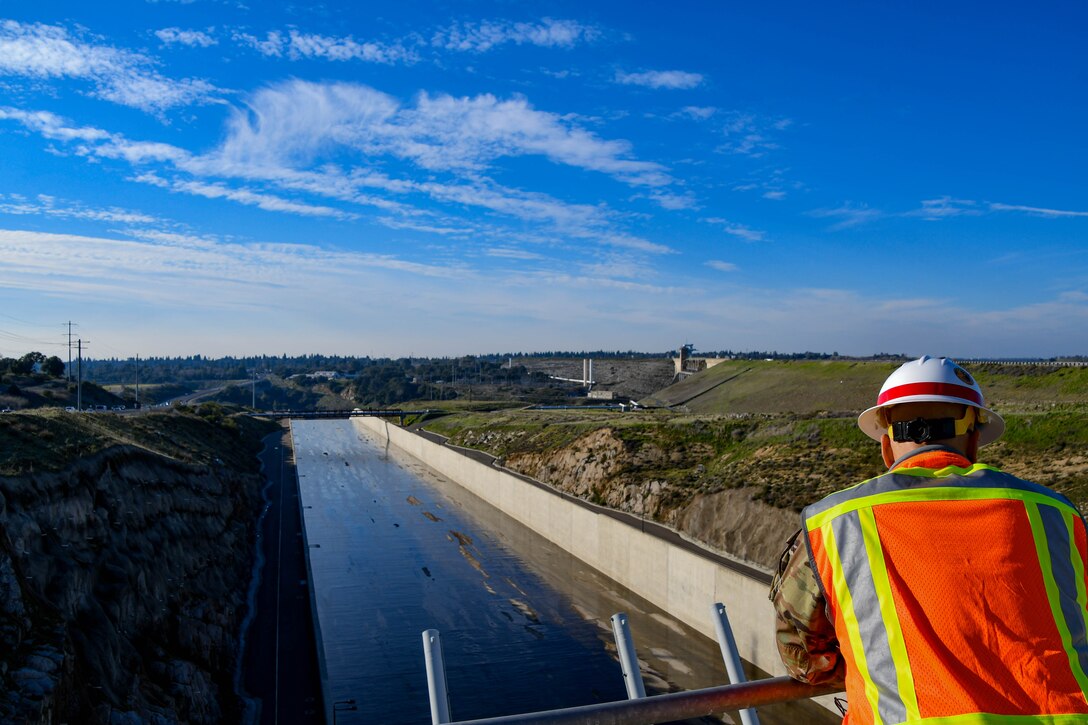 Col. Chad Caldwell, commander of the U.S. Army Corps of Engineers Sacramento District, overlooks the emergency spillway at Folsom Dam in Folsom, California, during a visit from South Pacific Division leadership on January 30, 2024. The spillway was a joint project of USACE and the Bureau of Reclamation, which operates Folsom Dam, completed in 2017. The ongoing Folsom Dam Raise, spearheaded by the Sacramento District, aims to raise Folsom Dam’s component facilities by 3.5 feet to increase the temporary capacity of the reservoir in extreme flood conditions.