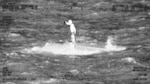 A mariner in distress standing on top of his capsized vessel approximately 35 miles off Boynton Beach in the Florida Straits, April 6, 2025. A Coast Guard Cutter Spencer (WMEC-905) boat crew arrived on scene and rescued the man with no medical concerns reported. (U.S. Coast Guard photo)
