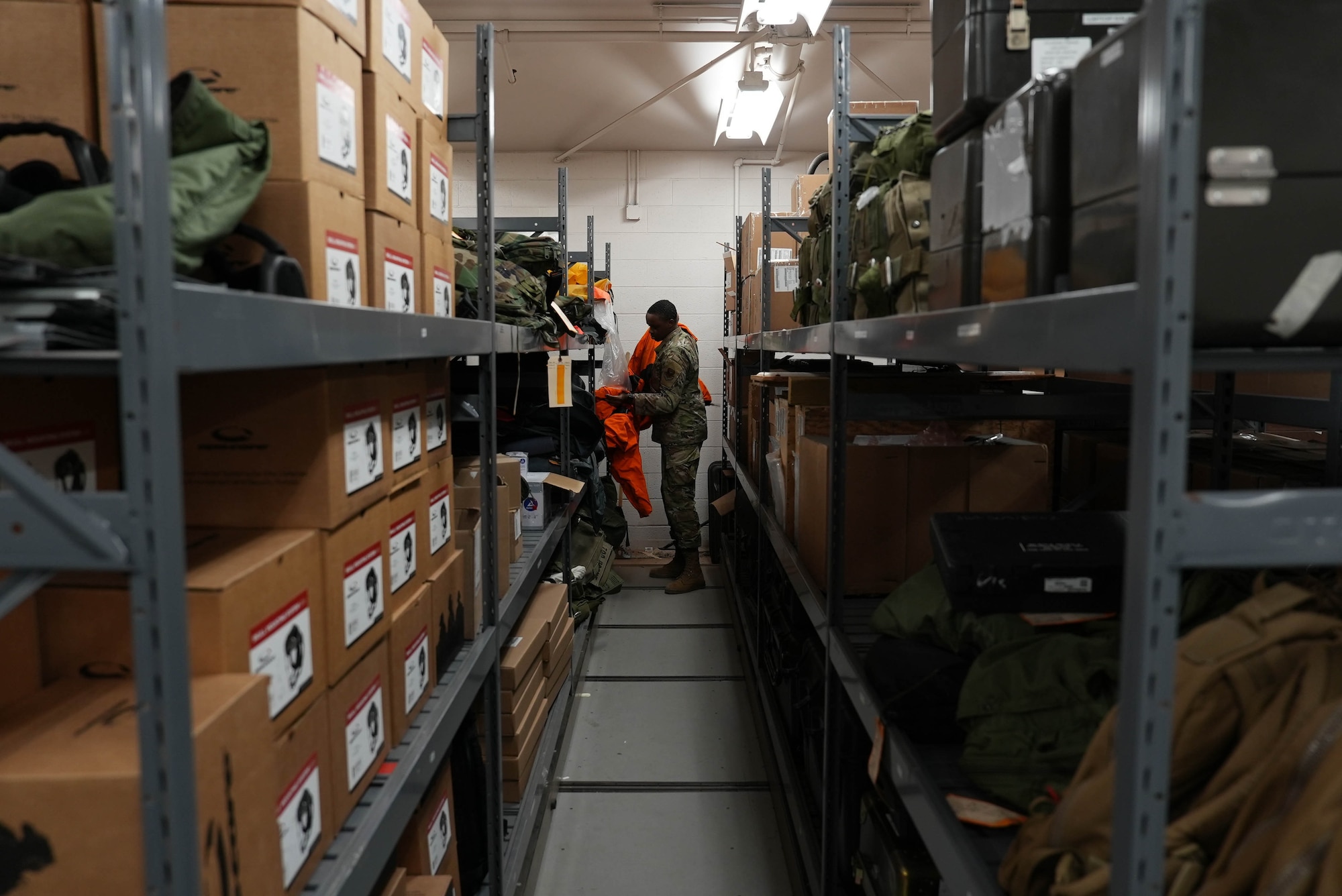 An Air Commando retrieves a Viking Suit from a shelf inside an aircrew flight equipment section at Cannon Air Force Base, New Mexico, March 17, 2025. The high standards and readiness maintained by AFE specialists directly contributes to success in life-and-death scenarios faced by aircrew members. (U.S. Air Force photo by Staff Sgt. Kevin Williams)
