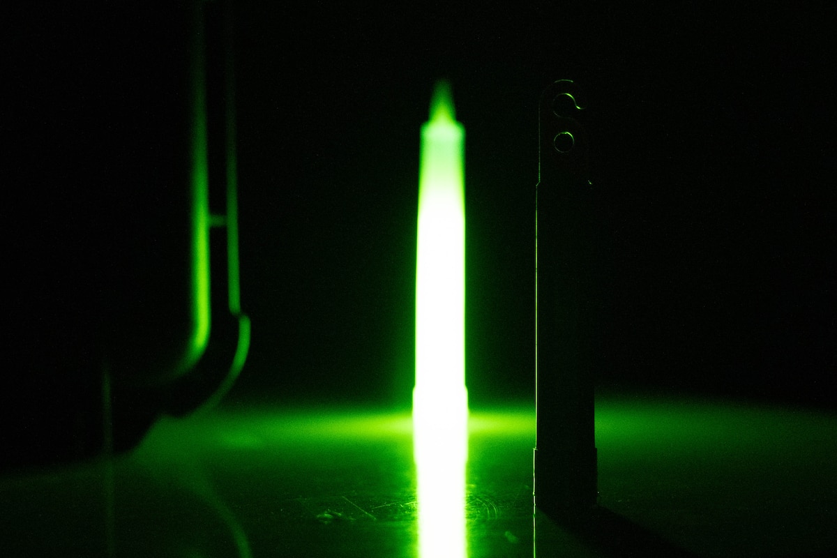 An ultraviolet and standard glow stick are displayed side-by-side