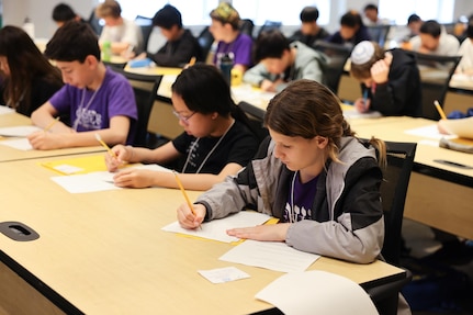 Students solve timed math problems during the individual written portion of the Carderock Math Contest (CMC) in West Bethesda, Md., April 4, 2025.
