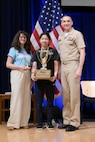 Alice Wang, a student at Longfellow Middle School, proudly holds her first place trophy alongside Carderock’s Chief of Staff, Stephanie Feulner (left) and Carderock’s Commanding Officer, Capt. Chris Matassa (right).
