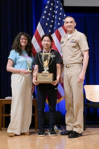 Alice Wang, a student at Longfellow Middle School, proudly holds her first place trophy alongside Carderock’s Chief of Staff, Stephanie Feulner (left) and Carderock’s Commanding Officer, Capt. Chris Matassa (right).