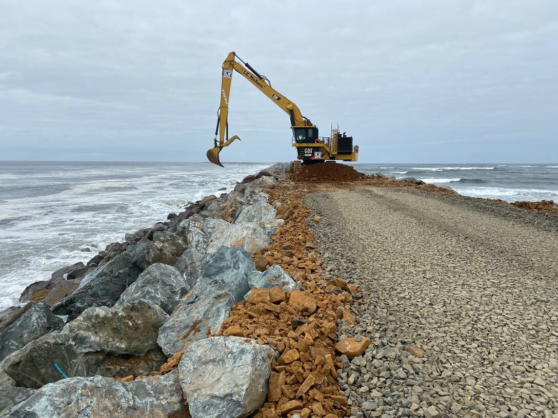 An excavator on top of the south jetty is pictured.