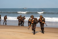 Indian Army personnel from the 4/8 Gurkha Rifles Infantry Battalion, 91st Infantry Brigade, land on the beach from landing crafts mechanised (LCM-8) launched from Indian Navy amphibious transport dock INS Jalashwa (L41) during a large-scale amphibious landing drill held as part of Exercise Tiger Triumph 2025, at Kakinada Beach, Andhra Pradesh, India, April 11.