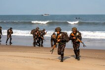 Indian Army personnel from the 4/8 Gurkha Rifles Infantry Battalion, 91st Infantry Brigade, land on the beach from landing crafts mechanised (LCM-8) launched from Indian Navy amphibious transport dock INS Jalashwa (L41) during a large-scale amphibious landing drill held as part of Exercise Tiger Triumph 2025, at Kakinada Beach, Andhra Pradesh, India, April 11.