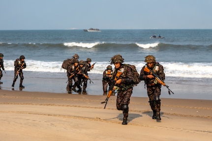 Indian Army personnel from the 4/8 Gurkha Rifles Infantry Battalion, 91st Infantry Brigade, land on the beach from landing crafts mechanised (LCM-8) launched from Indian Navy amphibious transport dock INS Jalashwa (L41) during a large-scale amphibious landing drill held as part of Exercise Tiger Triumph 2025, at Kakinada Beach, Andhra Pradesh, India, April 11.