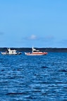 Maritime law enforcement and emergency responders from the Guam Port Authority and Guam Fire Department conduct training in Apra Harbor, Guam, as part of the NASBLA Boat Crew Member Course on March 27, 2025.