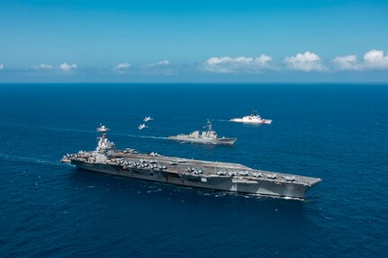 Two F/A-18E Super Hornets, attached to the "Tomcatters" of Strike Fighter Squadron (VFA) 31, fly over the world's largest aircraft carrier, USS Gerald R. Ford (CVN 78), the Arleigh Burke-class guided-missile destroyer USS Winston S. Churchill (DDG 81), and the U.S. Coast Guard Cutter (USCGC) James (WMSL 754), April 2, 2025. The Gerald R. Ford Carrier Strike Group is underway in the Atlantic Ocean completing integrated naval warfighting training. Composite Training Unit Exercise (COMPTUEX) is the Joint Force’s most complex integrated training event and prepares naval task forces for sustained high-end Joint and combined combat. Integrated naval training provides America’s civilian leaders and commanders highly-capable forces that deter adversaries, underpin American security and economic prosperity, and reassure Allies and partners. (U.S. Navy photo by Mass Communication Specialist 2nd Class Maxwell Orlosky)