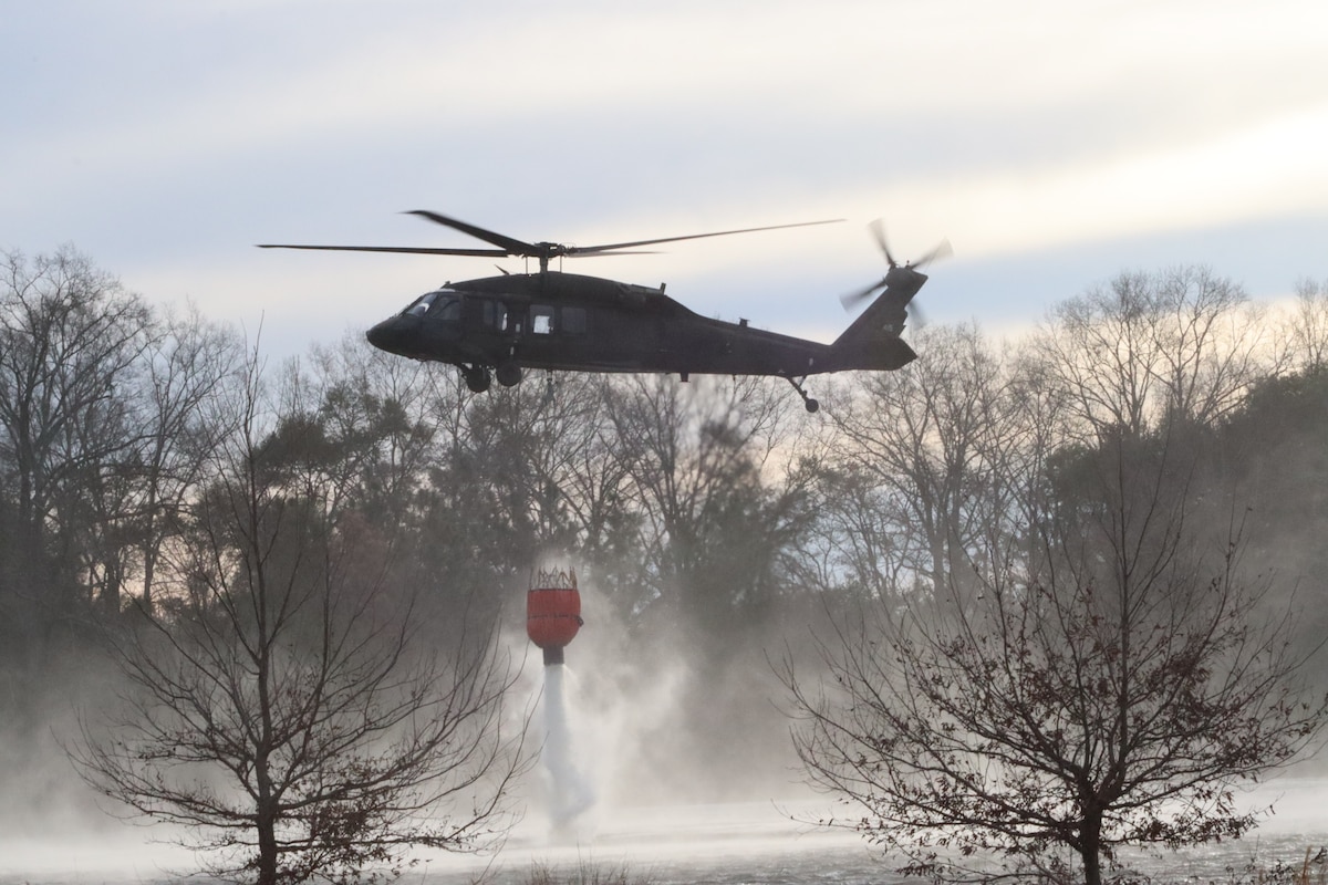 A U.S. Army UH-60 Black Hawk and crew from the 2nd Brigade, 135th General Support Aviation, Colorado Army National Guard perform water bucket drops over Chatfield Reservoir in Littleton, Colorado, April 17, 2021. LUH-72 Lakota, UH-60 Black Hawk, and CH-47 Chinook aircrews flew over the Denver metropolitan area as part of the annual wildland fire training conference. (U.S. Army National Guard photo by Sgt. Ashley Low)